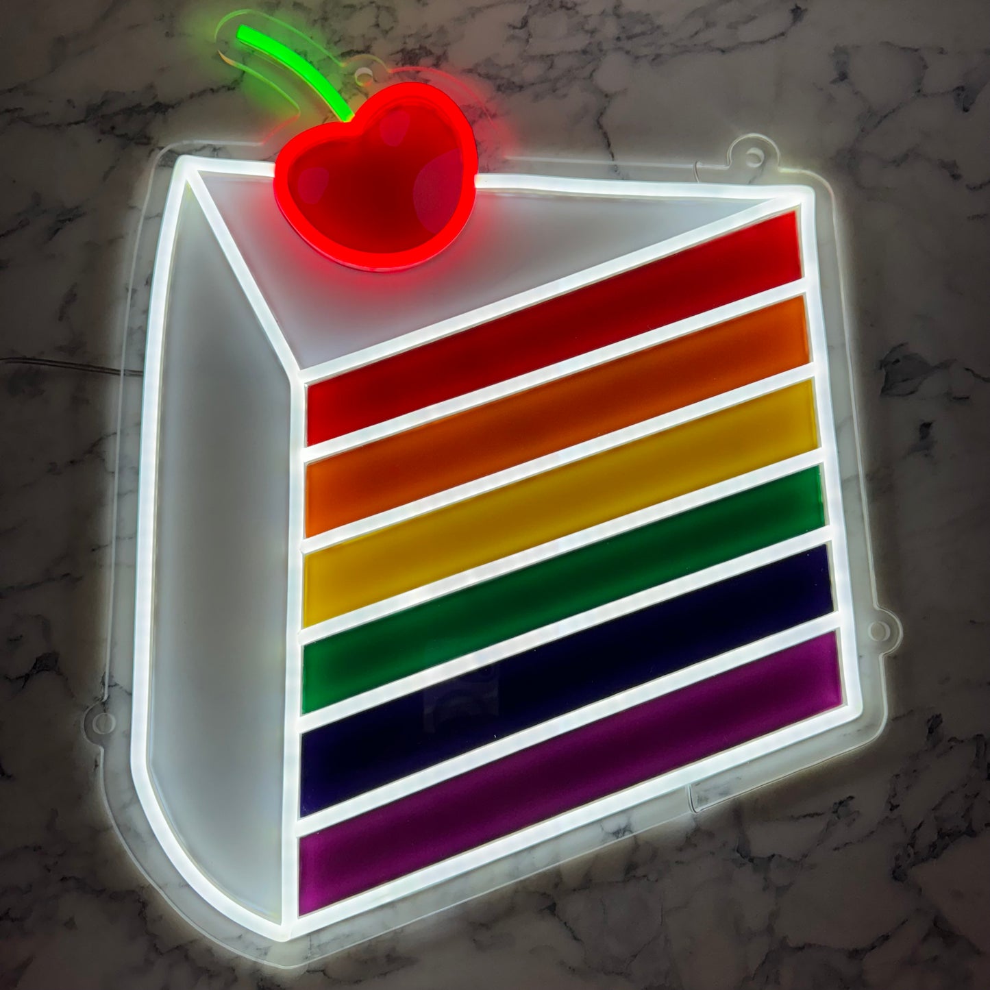 A Rainbow Cake Slice LED Neon Sign. 